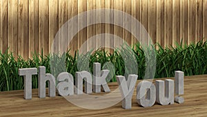 Poster lettering Thank You. Large letters on a wooden table. Modern decorative grass, backlit wall of wooden battens. Great loft