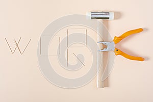 Poster made with chopsticks, pliers and a hammer that shows the text WORK.The photograph is a horizontal shot taken with photo