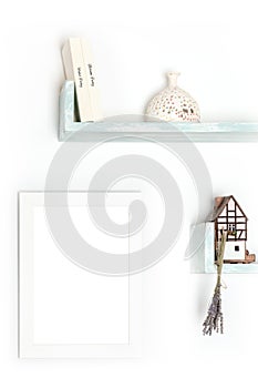 Poster mock-up. A blank frame on a wall with books and objects