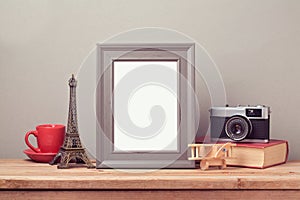 Poster mock up template with Eiffel Tower and vintage film camera. Travel and tourism