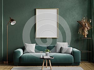 Poster mockup with vertical frame on empty dark green wall with green velvet sofa