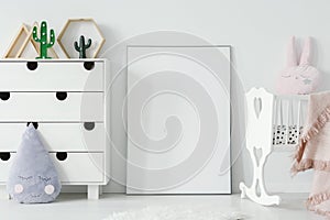 Poster with mockup between white cradle and cabinet in child`s r