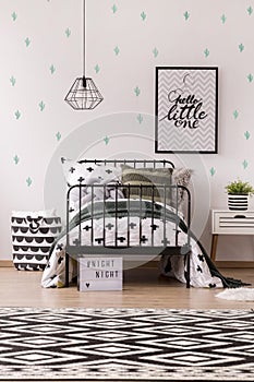 Poster in patterned child`s bedroom