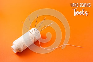poster or postcard template with text hand sewing tools, needle and thread on orange background