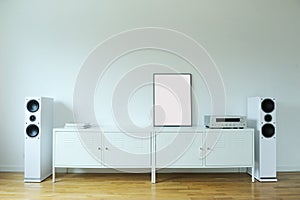 Poster on table in room.Poster Frame Mockup in white modern interior. Modern audio stereo system with white speakers on bureau in