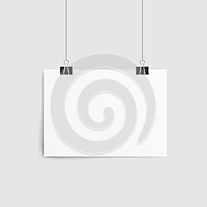 Poster template of a paper sheet. Empty paper frame mockup hanging with paper clip.