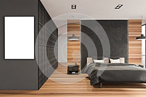 Poster in wooden bedroom space with robust black wall partition