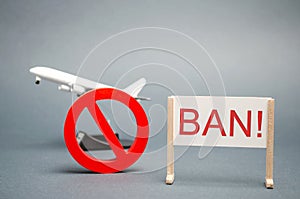 A poster with the word Ban. The sign of the ban and a miniature toy aircraft. Ban on flights of civil aircraft. Forbidden zone.