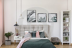 Posters in bright bedroom interior