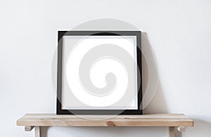 Posters square format in black frame in white stylish modern interior on shelf, living room. Design template mockup
