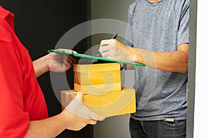 Postman delivering package of goods to home. Selective focus on the hands. Home delivery concept, Deliver packages to recipients