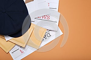 Postman hat, newspapers and mails on light brown background, flat lay. Space for text