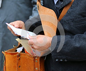 postman with the old bag while delivering mail