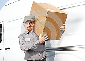 Postman with parcel near delivery truck.