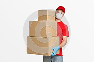 Postman in protective mask and gloves holds many parcels photo