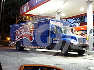 Postobon truck on gas station
