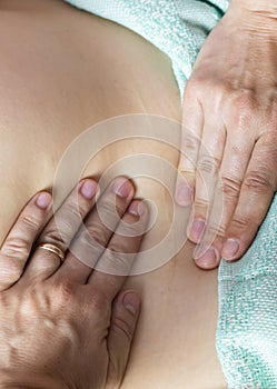 Postpartum doula shows how to massage a cesarean scar.