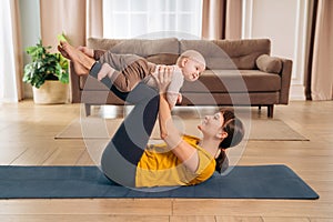 Postpartum recovery. Mommy practicing yoga with her baby