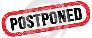 POSTPONED, text written on red-black stamp sign