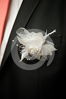 Posy with decorate rose on groom wedding suit