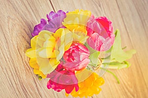 Posy of spring flowers on wooden table