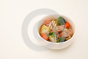 pot-au-feu vegetables sausage soup isolated on white background