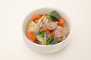 pot-au-feu vegetables sausage soup isolated on white background