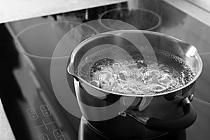 Pot with boiling water on electric stove