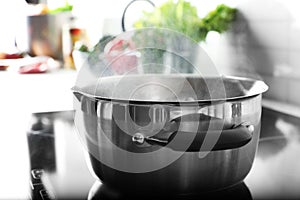 Pot with boiling water on electric stove