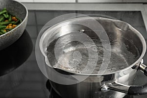 Pot with boiling water on electric stove