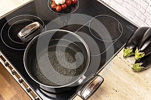 a pot of boiling water on an electric stove in the kitchen