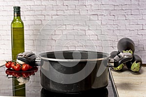 a pot of boiling water on an electric stove in the kitchen