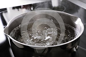 Pot with boiling water on stove