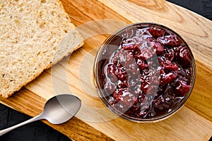 Pot with cherry jam and toast bread