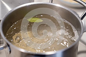 In a pot, colorful dumplings are being boiled. Preparing lunch or dinner