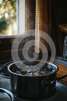 Pot filled with potatoes and boiling water on a stove