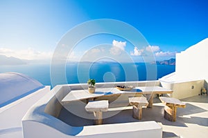 A pot with flower and a plate on a wooden table with ocean background, Santorini.