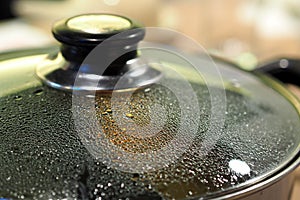 Pot with glass lid closeup to see water steam drops