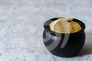 Pot of gold bitcoins on a white and gray crackle background