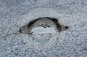 A pot hole in the asphalt