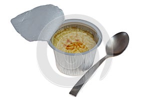 Pot of open industrial rice pudding with a spoon isolated on white