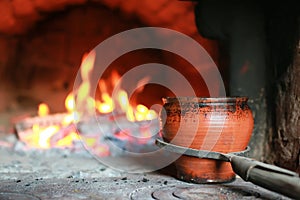 Pot in oven with food the oven fork