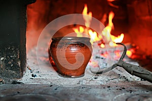 Pot in the oven with food the oven fork