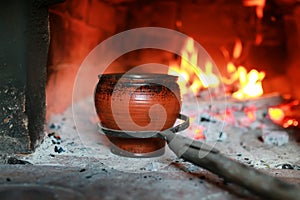 Pot in the oven with food the oven fork