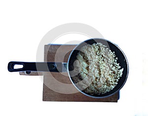 Pot with rice on wooden board with white background. Guatemala food concept