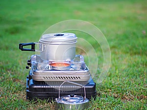 Pot stands on a portable gas stove. cooking on camping concept.