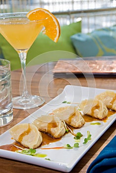 Pot stickers with an orange martini