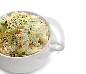 Pot with tasty boiled rice and avocado on white background