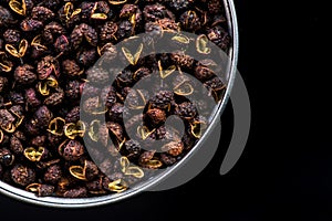 Pot with Timut Nepalese pepper on dark