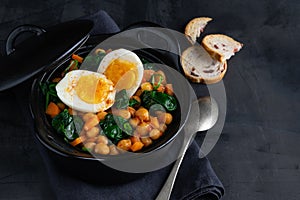 Potaje de Garbanzos chickpea stew Spanish recipe traditional with ingredients on a dark background with copy space